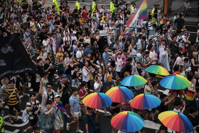 Participants march on a street in Seoul during the Gay Pride March on July 15, 2017.