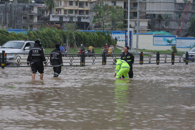 Les inondations ont fait un mort et les vents violents ont blessé trois personnes – ici des gens occupés à drainer l’eau d’une rue de Sanya, dans la province de Hainan, dans le sud de la Chine, après le passage du typhon Doksuri, le 15 septembre 2017.