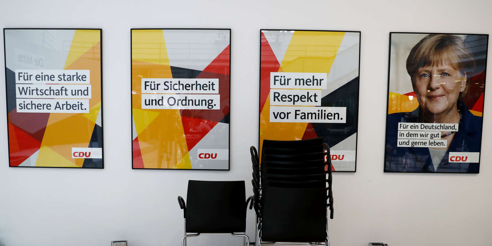 Posters of Christian Democratic Union CDU party leader and German Chancellor Angela Merkel and of CDU election campaign slogans are seen at the CDU party headquarters, a day after the general election (Bundestagswahl) in Berlin, Germany September 25, 2017. Posters read: 'For a strong economy and job security', 'For security and order', 'For more respect of families' and 'For a Germany that we like to live in'. REUTERS/Kai Pfaffenbach