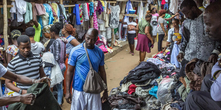 13th July 2017. Lome, Togo.
Amah Ayivi, shopping for vintage clothes at the second-hand items section of the Hedzranawoe market in Lome, Togo.
