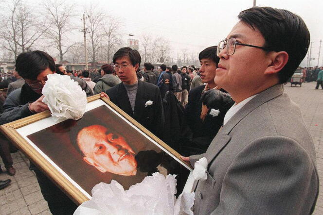 Le public attend le passage du convoi funéraire de Deng Xiaoping, sur la route du cimetière révolutionnaire de Babaoshan, à Pékin, le 24 février 1997.