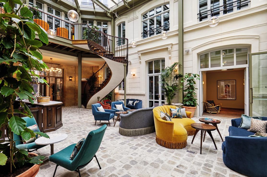 A modern and elegant Parisian hotel lobby.