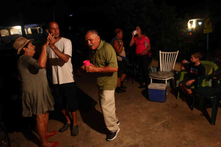 Des habitants d’El Sato, à Morovis, font la fête pour la nouvelle année, éclairés par les générateurs.