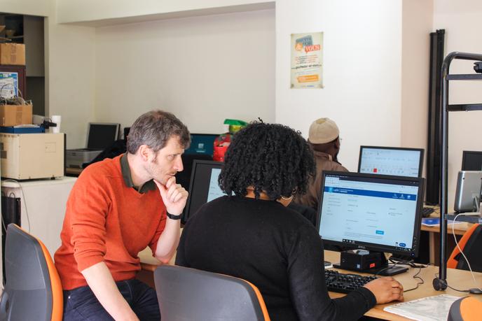 Marie est venue profiter de la permanence de libre accès aux ordinateurs pour se connecter à son compte CAF. Le bénévole de la permanence l’aide à se repérer sur le site.