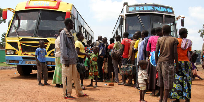 Au centre de réception de Kuluba, des réfugiés sud-soudanais s’apprêtent, le 30 juillet 2017, à monter dans un bus pour rejoindre une zone d’installation où ils pourront s’établir.