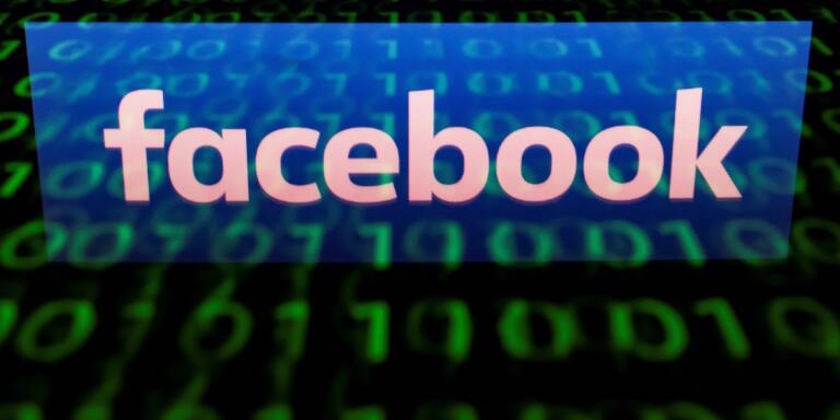 (FILES) In this file photo illustration picture taken on April 29, 2018,  the logo of social network Facebook is displayed on a screen and reflected on a tablet in Paris.  Thousands of Facebook and Instagram advertisements taken out by a Russian internet group were released May 10, 2018 in a database that illustrate how a concerted effort was made to foment anger and split US society around the 2016 election. Democrats of the House Intelligence Community released records of more than 3,000 ads from 2015-2017 that were allegedly placed by the Kremlin-linked Internet Research Agency, a Saint Petersburg operation that allegedly spreads disinformation and political propaganda across the internet and social media in Russia and in countries where Moscow wants to influence politics.
 / AFP / Lionel BONAVENTURE
