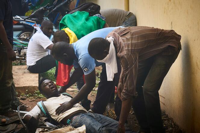 Un blessé est secouru lors de la manifestation de l’opposition à Bamako, samedi 2 juin.