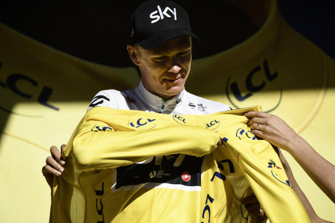 Great Britain's Christopher Froome puts his overall leader yellow jersey on the podium at the end of the 181,5 km fourteenth stage of the 104th edition of the Tour de France cycling race on July 15, 2017 between Blagnac and Rodez.