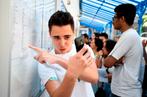 ERIC FEFERBERG / AFP A student poses with a smartphone as he reacts with others after receiving their baccalauréat examination results at a lycee in Paris on July 6, 2018. End of the suspense for the 750,000 baccalaureate candidates: the results have begun to arrive, bringing as every year their share of emotions, between relief, joy and disappointment. / AFP / Eric FEFERBERG
