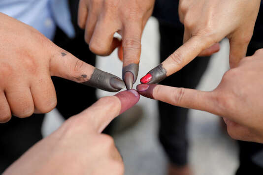  Every voter had to plunge his finger in the black ink, after slipping its ballot in the urn. 
