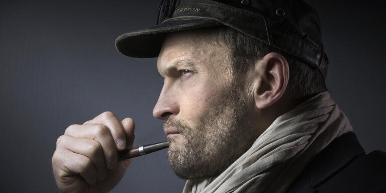 French writer Sylvain Tesson poses with a pipe during the presentation of the 