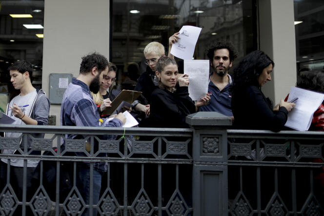 Des Argentins font la queue pour remplir un formulaire de renoncement à l’Eglise catholique (apostasie), à Buenos Aires, le 18 août.