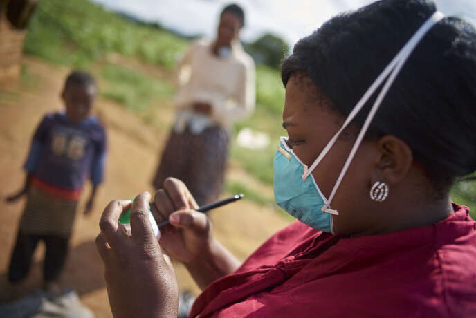Consented, but Identities to be protected. During a home visit, Faith Slamini (red shirt), Cough Monitor from at the TB Clinic in Baylor Tuberculosis Centre of Excellence, collects sputum samples from a family in a village about 10 km out of Mbabane, Swaziland.