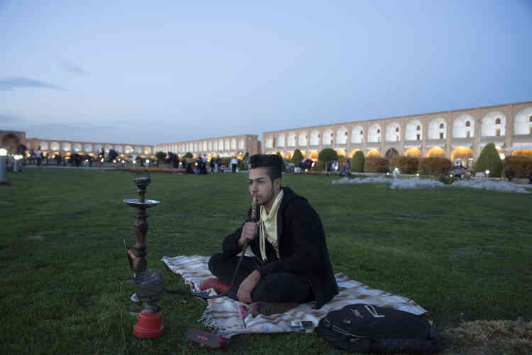 Ahmad, 28 ans, fume la chicha sur la place Naghsh-e Jahan, dans le centre historique d’Ispahan, le 25 octobre 2018.