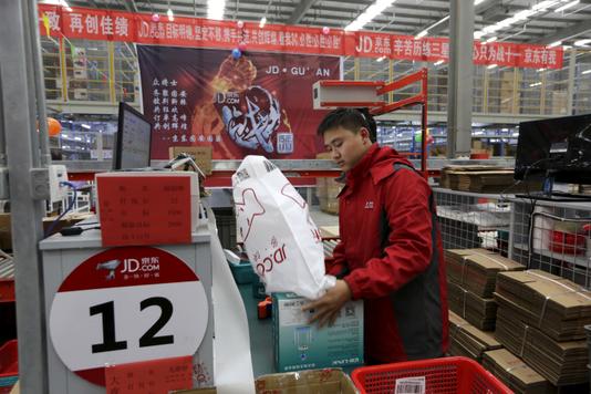 Jason Lee / REUTERS An employee prepares orders at the JD.com online sales platform logistics center in Langfang, China, in November 2015.