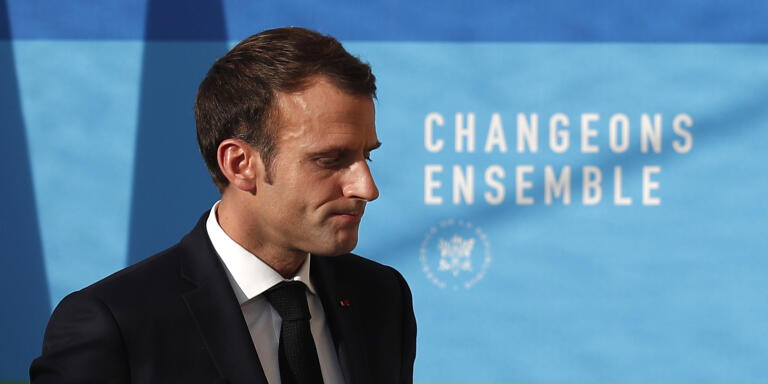 French President Emmanuel Macron leaves after delivering a speech on 'The presentation of the strategy for ecology transition', at the Elysee Palace in Paris, Tuesday, Nov. 27 2018. Macron said the government will find a way to delay tax increases on fuel during periods when world oil prices are rising. The move aims to reproduce the situation that has led to protests in recent days, some of which have become violent and even marred the famed Champs-Elysees avenue in central Paris. Behind reads: Change together. (Ian Langsdon, Pool via AP)