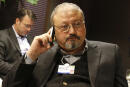 FILE - In this Jan. 29, 2011, file photo, Saudi Arabian journalist Jamal Khashoggi speaks on his cellphone at the World Economic Forum in Davos, Switzerland. Saudi Arabia issued an unusually strong rebuke of the U.S. Senate on Monday Dec. 17, 2018, rejecting a bipartisan resolution that put the blame for the killing of Saudi journalist Jamal Khashoggi squarely on the Saudi crown prince and describing it as interference in the kingdom's affairs. (AP Photo/Virginia Mayo, File)