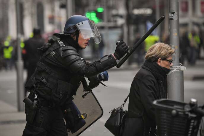 Un gendarme fait signe à une dame de s’éloigner en tenant un « tonfa », ou bâton de défense à poignée latérale, à Nantes, le 12 janvier.
