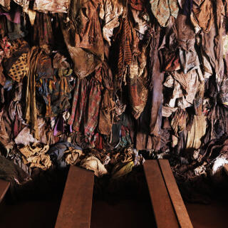 Bloodied and dust-covered clothing from Rwandan victims hang from a wall at a genocide memorial inside the church at Ntarama just outside the capital Kigali, August 6, 2010. Some 5,000 people, mostly women and children, sought refuge near the church in April 1994, but were massacred by Hutu extremists who used grenades, clubs and machetes to kill their victims. Rwandan voters go to the polls on Monday for the second presidential election since the genocide 16 years ago. REUTERS/Finbarr O'Reilly (RWANDA - Tags: POLITICS ELECTIONS CONFLICT) - GM1E6861D0I01