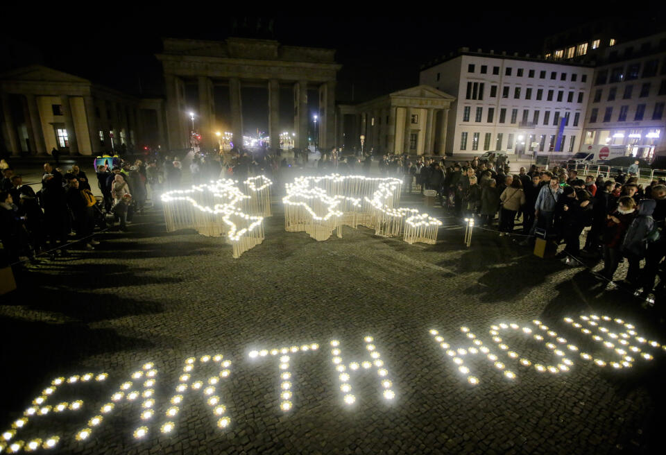Activists of the World Wide Fund For Nature (WWF) set up led-lights in front of the blacked out Brandenburg Gate to mark Earth Hour, in Berlin, Saturday, March 30, 2019. The global event Earth Hour is the symbolic switching off of the lights for one hour to help minimalize fossil fuel consumption as well as mitigate the effects of climate change. (AP Photo/Markus Schreiber)
