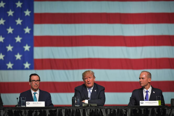 Le secrétaire  au Trésor, Steven Mnuchin,  le président Donald Trump  et le PDG de Boeing, Dennis Muilenburg, aux usines Boeing,  à Saint-Louis (Missouri),  le 14 mars 2018.