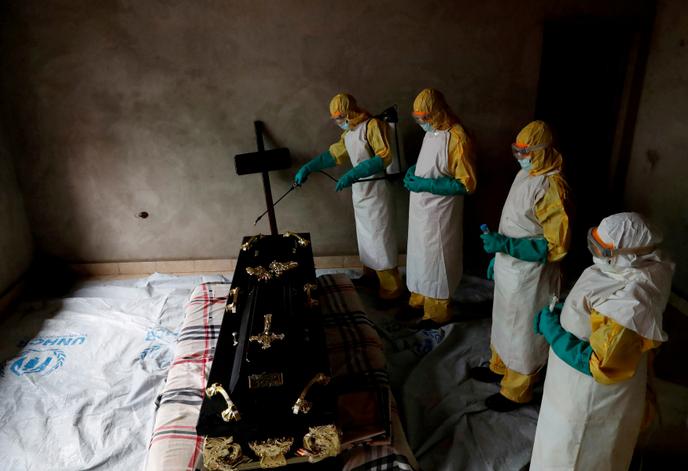 Des agents de santé lors des funérailles d’une personne dont la mort a pu être causée par Ebola, à Beni, en RDC, le 9 décembre 2018.