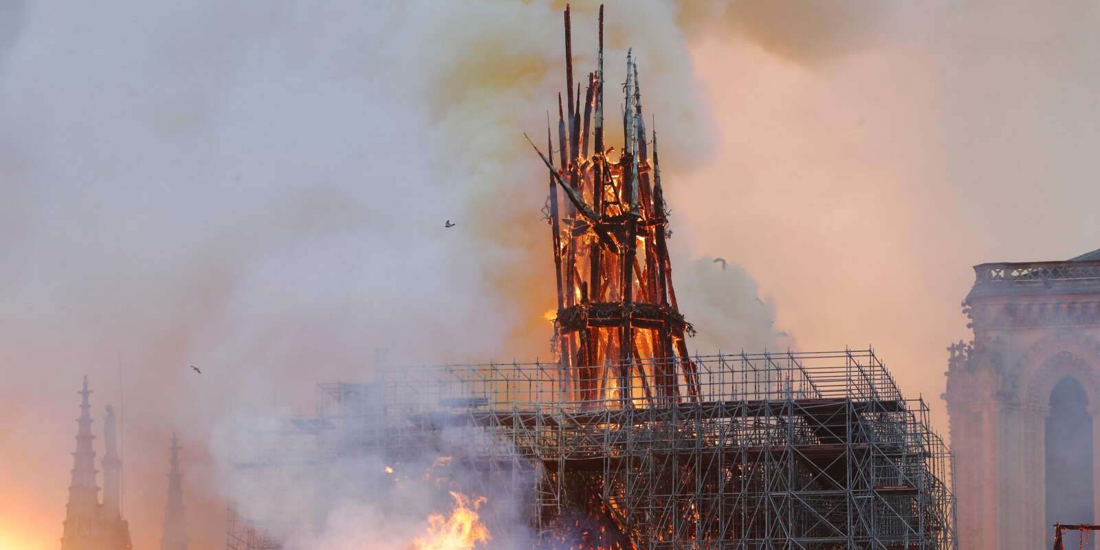 Smoke and flames rise during a fire at the landmark Notre-Dame Cathedral in central Paris on April 15, 2019, potentially involving renovation works being carried out at the site, the fire service said. A major fire broke out at the landmark Notre-Dame Cathedral in central Paris sending flames and huge clouds of grey smoke billowing into the sky, the fire service said. The flames and smoke plumed from the spire and roof of the gothic cathedral, visited by millions of people a year, where renovations are currently underway. / AFP / FRANCOIS GUILLOT