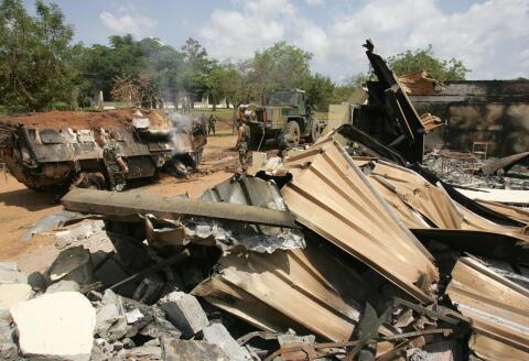 This general view shows French soldiers cleaning debris, 10 November 2004 at a bombed building they used at the Descartes lycee in Bouake. Nine French peacekeepers and a US civilian were killed 04 November 2004 when government SU-25 jets bombed a French military camp in Bouake in the course of what the government said were air strikes on rebel positions. AFP PHOTO PHILIPPE DESMAZES (Photo by PHILIPPE DESMAZES / AFP)