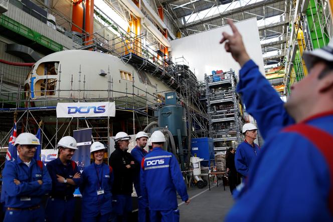 Workers of the French naval group work on a submarine, at Cherbourg-Octeville, in the English Channel, on December 14, 2016.