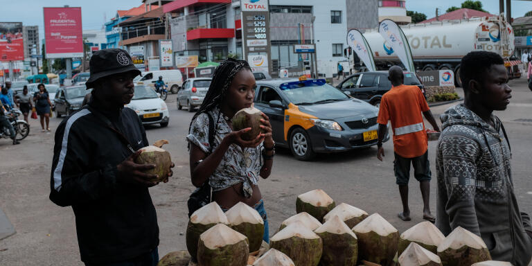Customers enjoy coconuts on Oxford Street in Osu. May 16, 2019. Ghana. Photo: Francis Kokoroko @accraphoto