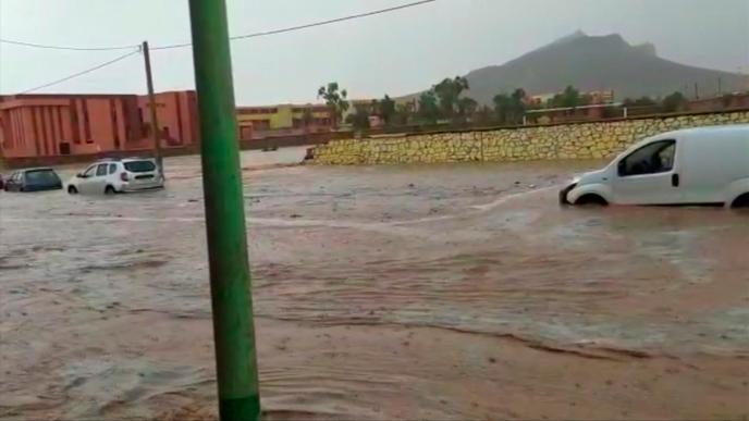Flood waters sweep through a town in the Ighrem region of Morocco, Wednesday Aug. 28, 2019, as heavy rain continues to fall. At least seven people watching a local soccer match in the southern Moroccan village of Tizert have died in a flash flood that swept across the football field, Wednesday, the official MAP news agency said. (Abdallah Darif via AP)