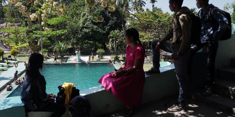 Local youths attend a spring-fed swimming pool, built during the Portuguese era, in Baucau, Timor-Leste, on Sunday, Aug, 25, 2019. Twenty years on from a referendum that brought independence from Indonesia after a brutal quarter-century conflict killed an estimated 100,000 people, Timor-Lestes birthing pains are evident everywhere. With almost half its 1.2 million people living in poverty, the aging war heroes still in charge are now betting big on a risky energy project that could draw one of the worlds youngest nations into a wider geopolitical tussle between the West and China. Photographer: Dimas Ardian/Bloomberg via Getty Images