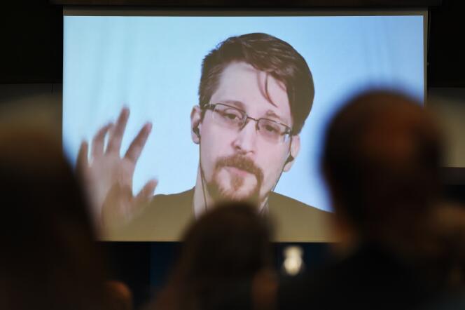 Former US National Security Agency (NSA) contractor and whistle blower Edward Snowden speaks via video link from Russia as he takes part in a round table meeting on the subject of 