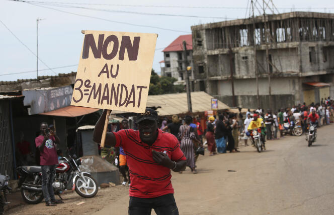 Un homme brandit une pancarte pendant la manifestation contre Alpha Condé jeudi 24 octobre à Conakry.