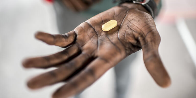 An HIV positive man holds a tablet, one of his medications, in his hand. After being diagnosed with HIV, he was kicked out of his house by his sister in law. He has been taking antiretroviral drugs (ARVs), which he collects from the Kabinda Hospital, and has almost recovered sufficiently to restart his work. *** Local Caption *** 
africa health medicine HIV/AIDS