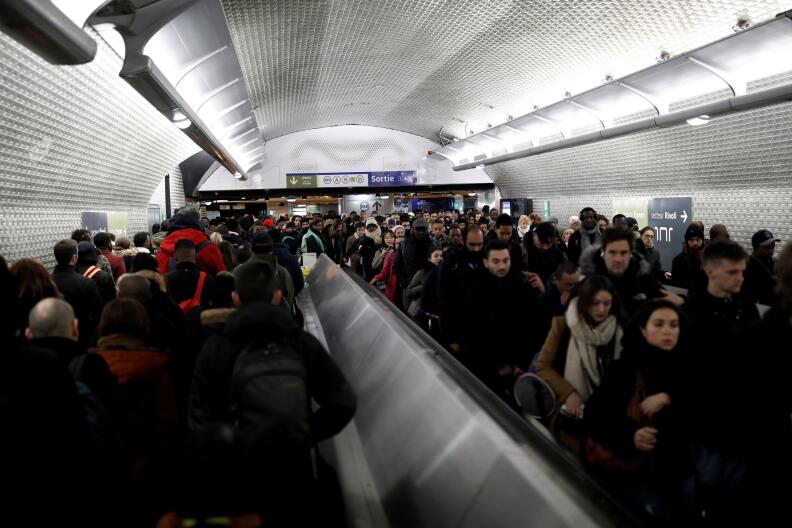 Commuters are seen in a corridor of the Chatelet subway station during a strike by all unions of French SNCF workers and the Paris transport network (RATP) in Paris as France faces its ninth consecutive day of strikes against French government's pensions reform plans, December 13, 2019. REUTERS/Benoit Tessier