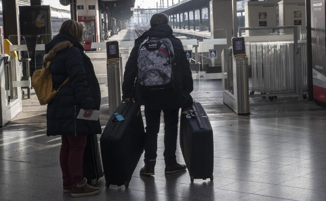 Travelers wait for a train at Gare de Lyon in Paris on December 29, 2019.