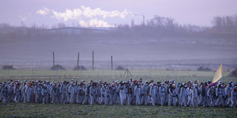 Supporters of the climate movement Ende Gelaende protest in front of a coal-fired power station Lippendorf near Leipzig, Germany, Sunday, Nov. 24, 2019. Ende Gelaende is an action alliance for an immediate coal exit, climate justice and a fundamental system change. The alliance announces a mass action of civil disobedience in the Saxony and Lusatian coal mining area in Germany. (AP Photo/Jens Meyer)