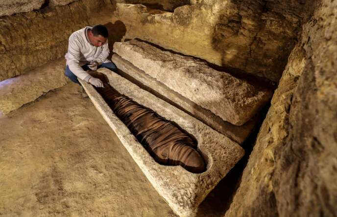 Le 30 janvier, un archéologue égyptien examine une momie découverte dans un sarcophage en calcaire à 300 km au sud du Caire.