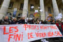 Teachers hold a banner reading "Teachers are not done emptying their bags" as they throw bags and school textbooks during the "The Education empties its bags" demonstration to protest against the education reforms and to call for more resources, in front of the Grand-Theatre in Bordeaux, southwestern France on January 22, 2020. (Photo by MEHDI FEDOUACH / AFP)