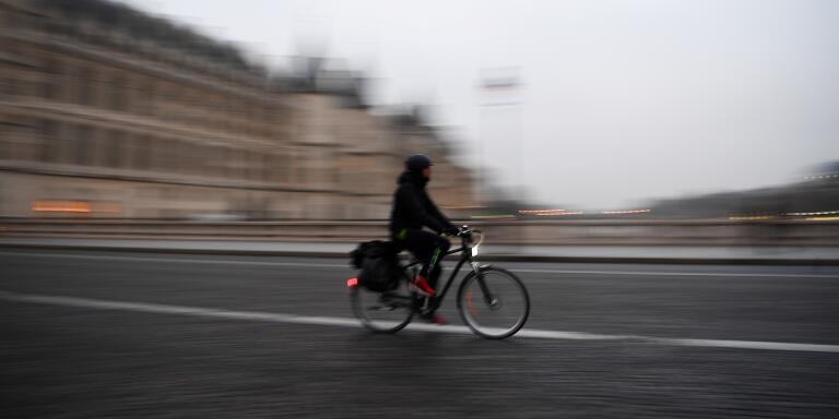 A man cycles in the streets of Paris during a national general strike that includes Paris public transports operator RATP employees over French government's plan to overhaul the country's retirement system, on December 5, 2019. - Trains cancelled, schools closed: France scrambled to make contingency plans on for a huge strike against pension overhauls that poses one of the biggest challenges yet to French President's sweeping reform drive. (Photo by CHRISTOPHE ARCHAMBAULT / AFP)
