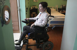 FILE - In this Dec. 18, 2019 file photo, Ana Estrada, a 42-year-old Peruvian psychologist who is almost completely paralyzed by a terminal illness and yearns to be legally allowed to end her own life, rides her motorized wheelchair through her home in Lima, Peru. The public defender‚Äôs office joined Estrada in filing a lawsuit Friday, Feb. 7, 2020, urging the Ministry of Health and other state institutions not to enforce a law punishing those who help terminal patients end their lives. (AP Photo/Martin Mejia, File)