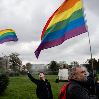People take part in a LGBT pride march where a strong police presence sought to prevent violence before forth coming parliamentary elections. *** Local Caption *** europe LGBT+ rights people activism flags human rights