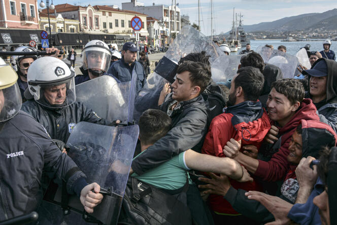 La police grecque repoussent des migrants dans le port de Mytilène, sur l’île de Lesbos, le 3 mars.