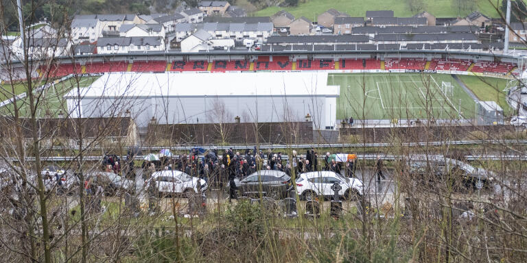 Funeral procession of Republican figure Liam Mccartney in Derry City Cemetary with Brandywell Stadium in the background. Creggan/Brandywell area of Derry.