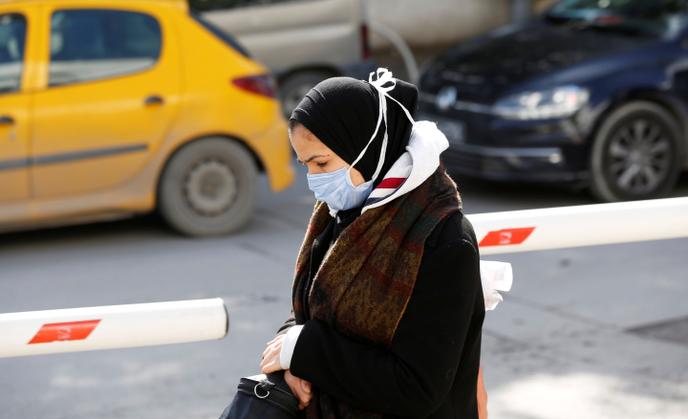 A woman wears a protective mask in Tunis, March 4, 2020.