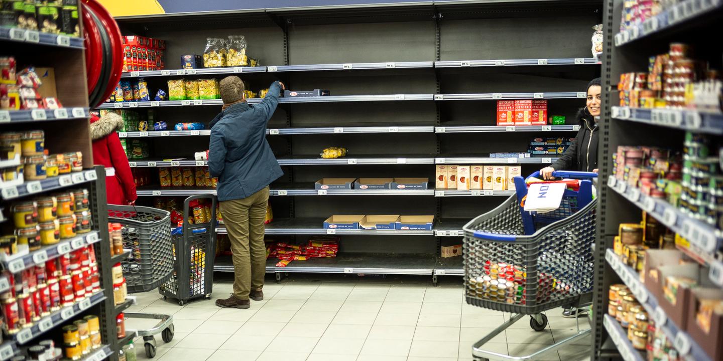 Jean-Franvßois Badias / AP A man picks up some pasta on empty shelf in a supermarket, Friday March, 13, 2020 in Strasbourg eastern France. For most people, the new coronavirus causes only mild or moderate symptoms. For some it can cause more severe illness, especially in older adults and people with existing health problems. (AP Photo/Jean-Francois Badias)