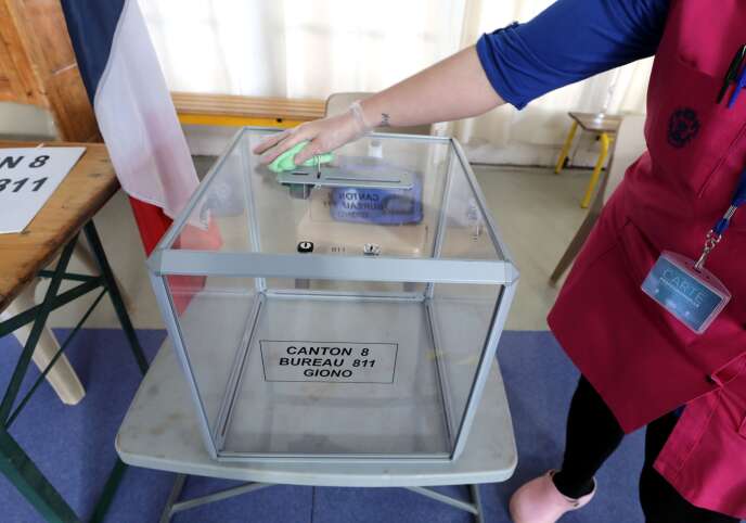 An employee cleans the ballot box for the municipal elections scheduled for Sunday at a polling station in Nice on Saturday March 14.