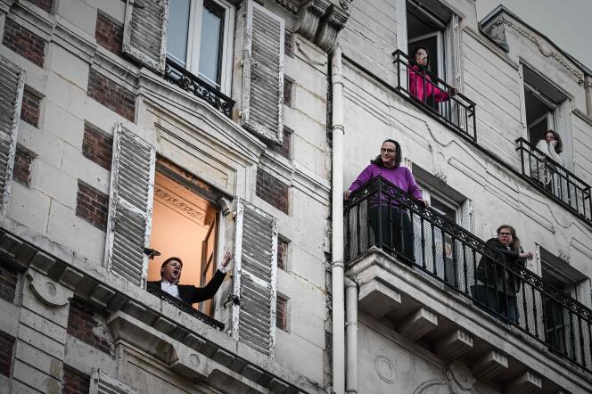 Des personnes confinées chez elle, à Paris, le 26 mars.