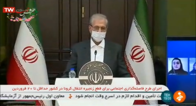Capture d’écran de la chaîne Shabaké 2 : le porte-parole du gouvernement Ali Rabiei porte un masque pour son point presse, diffusé au flash d’info de la télévision iranienne, le 30 mars.